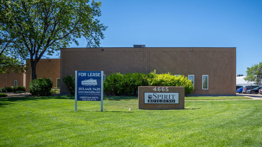 An exterior photo of the lawn, Spirit Building sign, and the building in the background